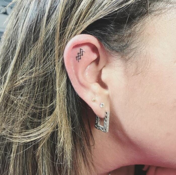 Aquarius Tattoos - Small delicate waves on ear