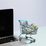 How to Stop Spending Money - mini shopping cart with cash inside